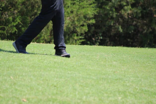A senior golfer's lower body when finishing a golf swing.