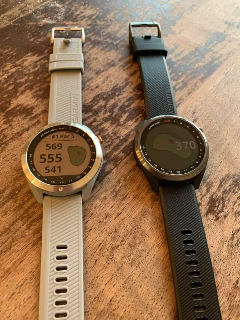 Two golf watches laying next to each other